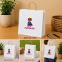 Bolsa de papel blanca personalizada con asas y logotipo para tiendas